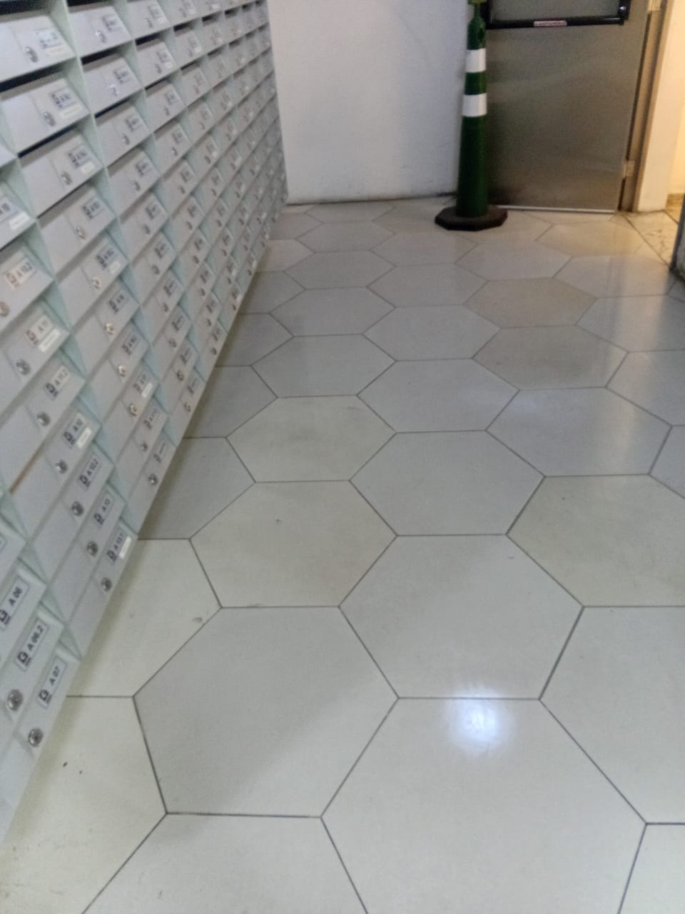 Piso hexagonal do hall de entrada depois da limpeza, rejunte e cerâmica claros